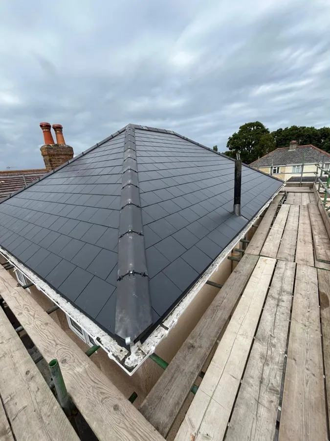 Completed hip roof re-covering photographed from the scaffold