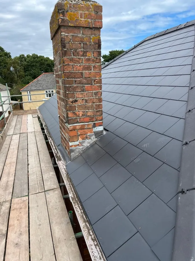 Newly tiled roof with the brick chimney re-flashed in lead