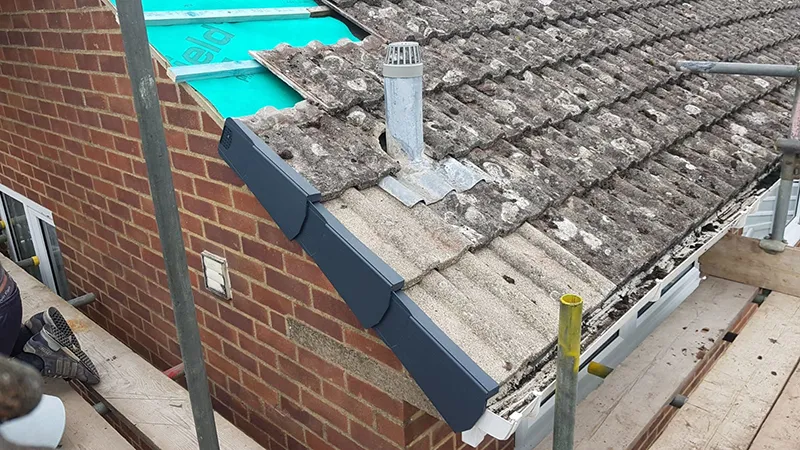New verge trim being fitted at a gable end during a roof upgrade